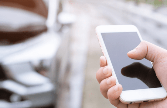 iphone user next to vehicle